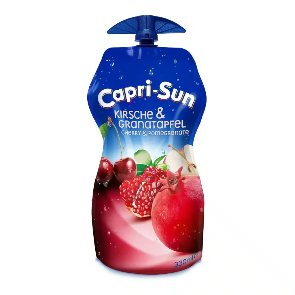 Capri-Sun juice pouch with blue top, showing cherries and pomegranate flavor (Kirsch & Granatapfel) label and 330 ml marking