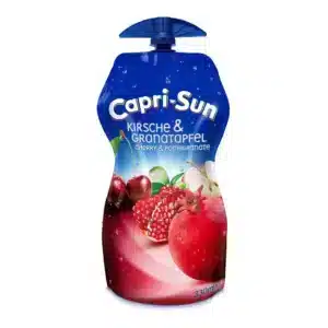 Capri-Sun juice pouch with blue top, showing cherries and pomegranate flavor (Kirsch & Granatapfel) label and 330 ml marking