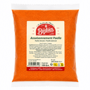 Orange paella seasoning mix in a sealed plastic bag with a beige label reading 'Assaisonnement Paella' and a red Bostan logo, visible granules inside the bag as well as text in French on the label for ingredients and usage.